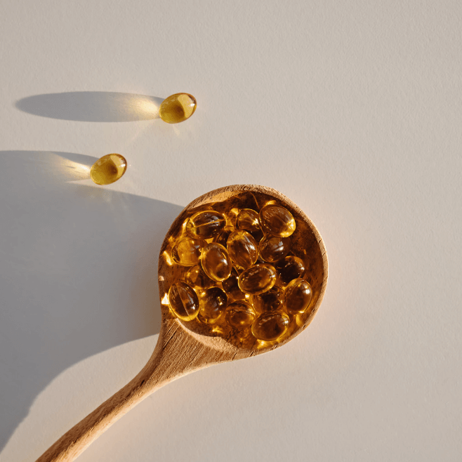 image of a spoon holding vitamin d supplements