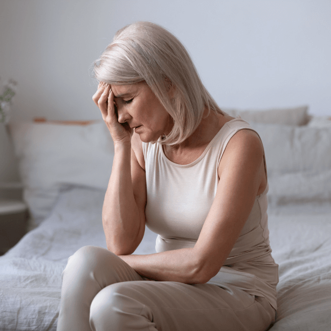 Woman suffering from menopause symptoms due to hormones and aging